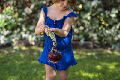 Full length of girl holding purple outdoors