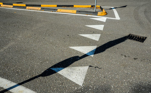 High angle view of arrow symbol on road in city