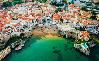 High angle view of townscape by sea