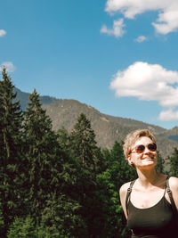Portrait of woman in sunglasses against sky