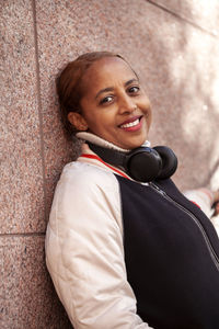 Portrait of young woman standing on street