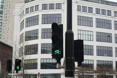 Road sign against buildings in city