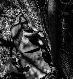 Two people climbing wall