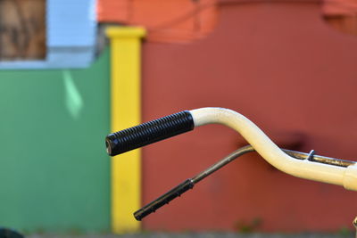 Close-up of bicycle handle against wall