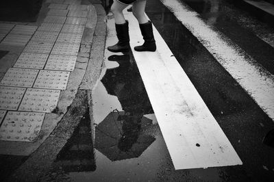 Low section of woman on wet street