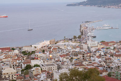 High angle view of townscape by sea against sky