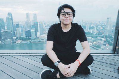 Portrait of mature man sitting in city