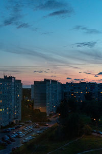 High angle view of illuminated buildings against sky at sunset