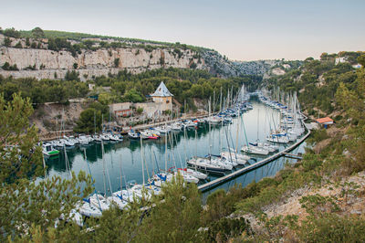 Boats anchored on harbor inside a cliff called calanque near cassis, france
