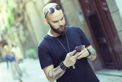 Midsection of man using mobile phone