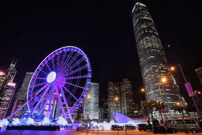 Low angle view of illuminated ferris wheel at night