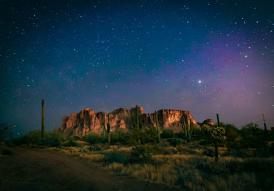 Scenic view of rock formation against sky at night