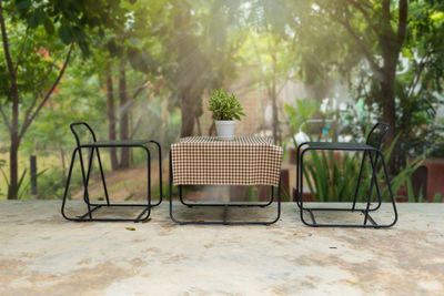 Empty chairs and tables in yard