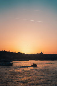 Scenic view of sea against clear sky during sunset