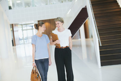 Young women in office building hall