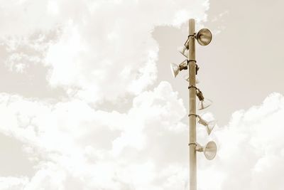 Low angle view of street light against cloudy sky