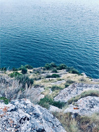 High angle view of rocks by sea