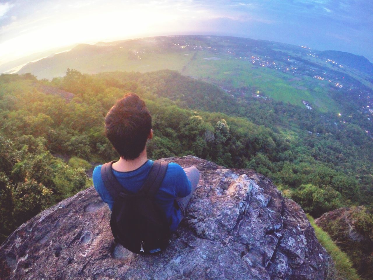 mountain, leisure activity, lifestyles, tranquil scene, beauty in nature, tranquility, scenics, landscape, nature, rear view, rock - object, sky, full length, men, sunlight, non-urban scene, casual clothing, idyllic