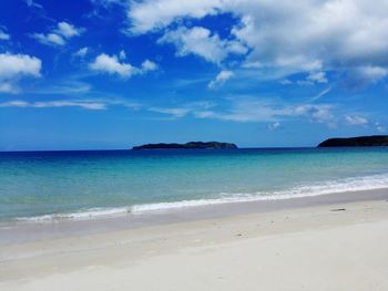 View of beach against cloudy sky