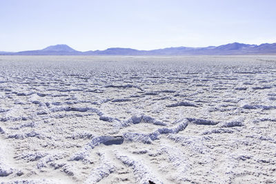 Scenic view of arid landscape against sky