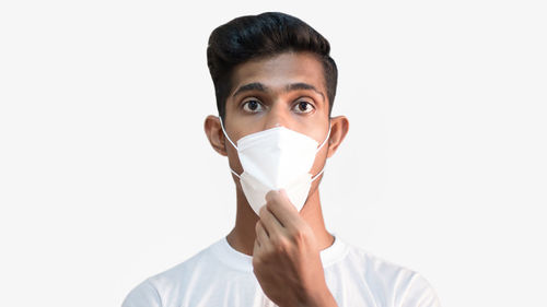 Portrait of young man against white background