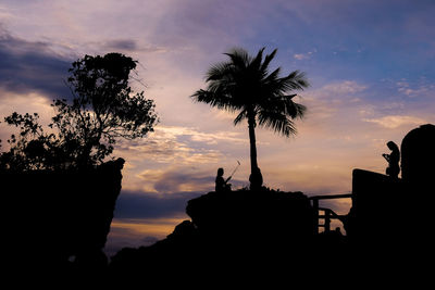 Silhouette trees against sky during sunset