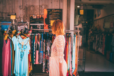 Rear view of woman standing at store