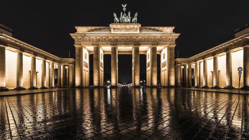 Illuminated brandenburg gate in rainy season at night