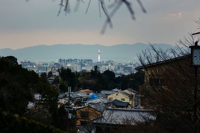 High angle view of houses and buildings in city during dusk