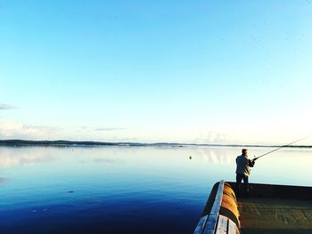 Rear view of man fishing