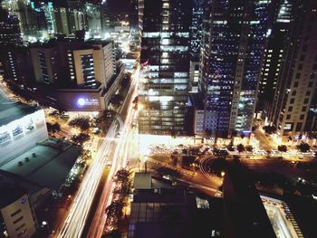 High angle view of illuminated city street and buildings at night
