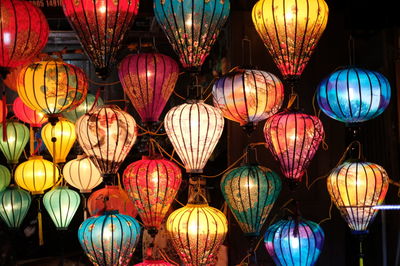 Multi colored illuminated lanterns hanging at night