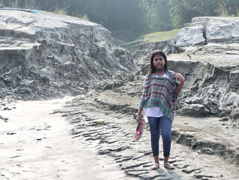 The girl standing on ground with soil background