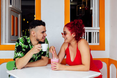 Young couple sitting on table at restaurant