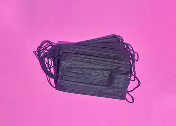 High angle view of telephone on table against pink background