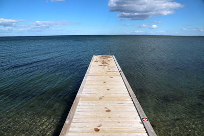 Pier over sea against sky