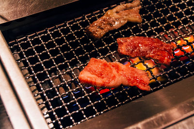 Close-up of meat cooking in barbecue grill