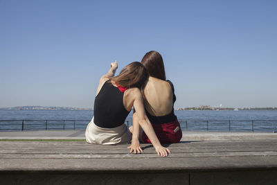 Back view of two young women sitting down