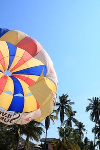 Low angle view of balloons against blue sky