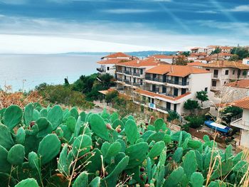 High angle view of townscape by sea against sky