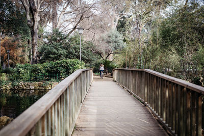 Footbridge amidst trees in park