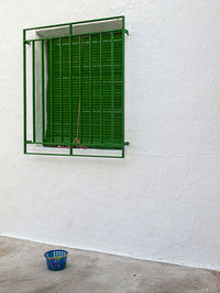 Closed window on white wall of building