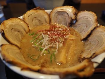 Close-up of meat with soup in bowl