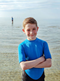 Portrait of boy standing on beach
