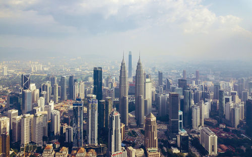 Aerial view of modern buildings in city against sky