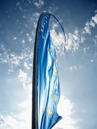 Low angle view of flag against blue sky