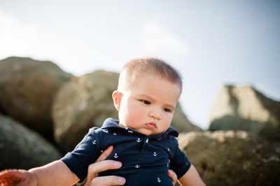 Seven month old mixed race boy at beach