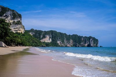 Scenic view of beach against blue sky