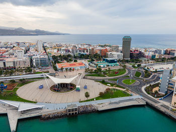 High angle view of buildings by sea against sky