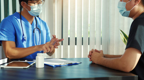 Midsection of couple standing on table